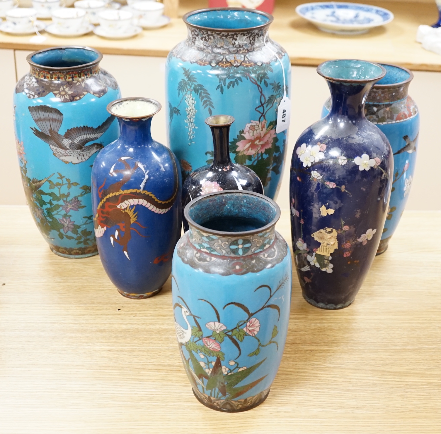 Seven Japanese cloisonné enamel vases, enamelled with dragons, flowers and birds, largest 40cm high